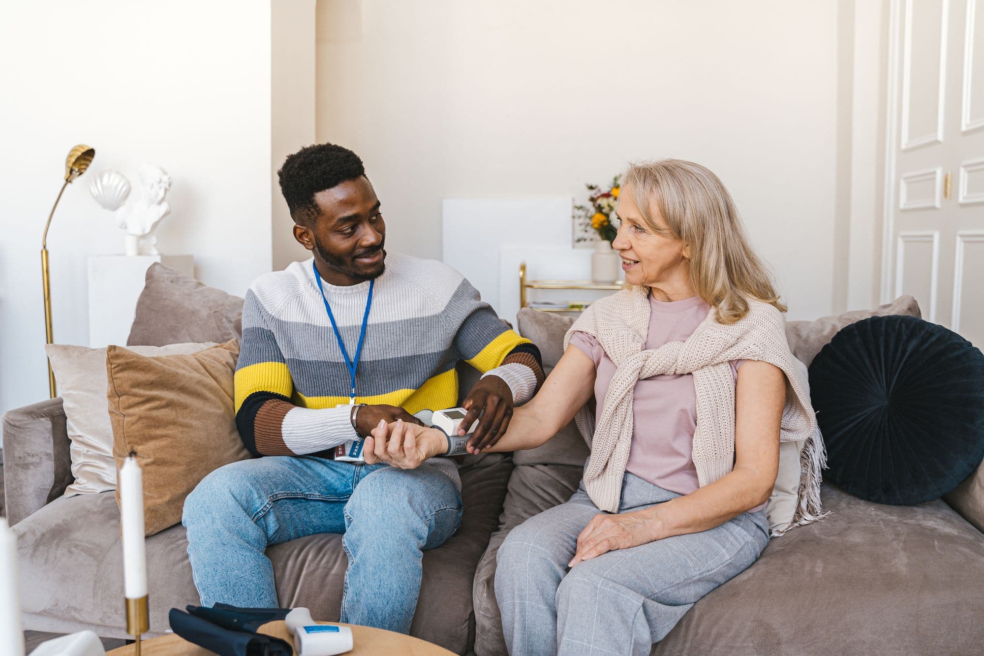 A CareBridge RN talking with a patient during a home visit