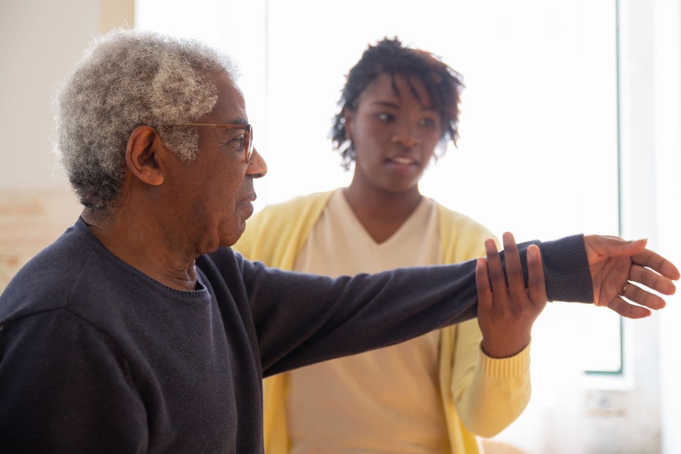 An RN supporting a patient with mobility during a home visit